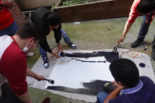 Members applying the first coat of paint