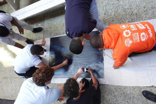 Members applying the first coat of paint